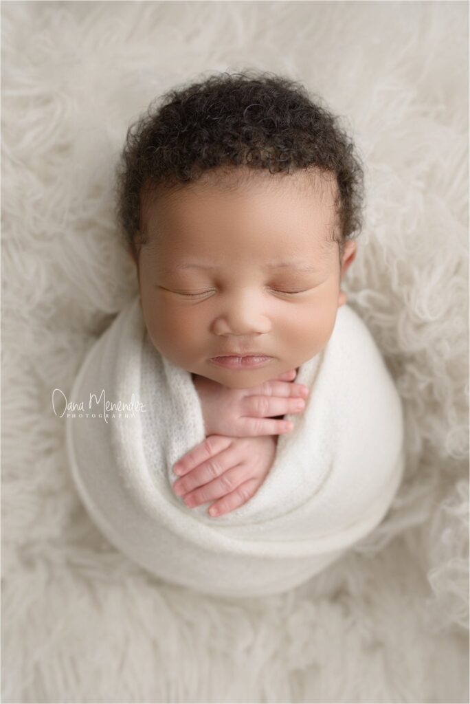 Baby sleeping peacefully in a cozy wrap.