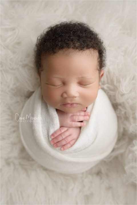 wrapped up little newborn boy
