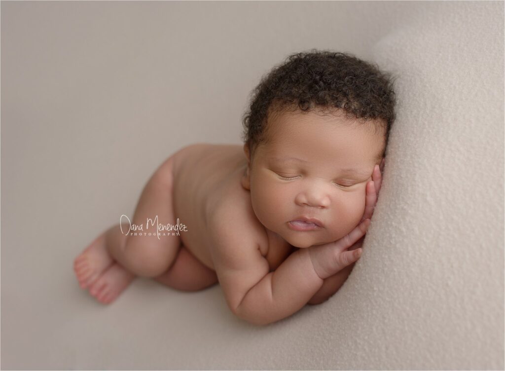 Baby sleeping peacefully on a soft surface, captured in a gentle, natural pose.