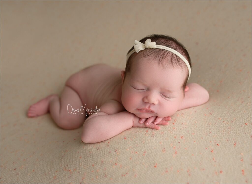 Baby girl peacefully sleeping on a soft blanket.