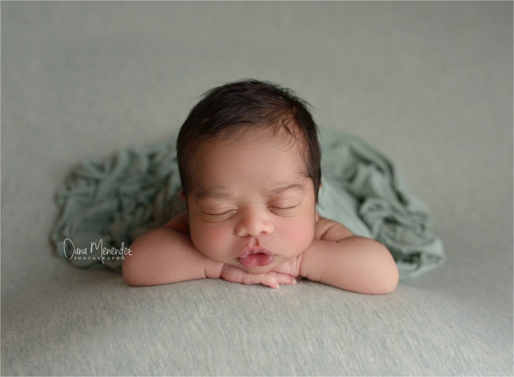 Adorable newborn baby peacefully sleeping on a soft blanket.