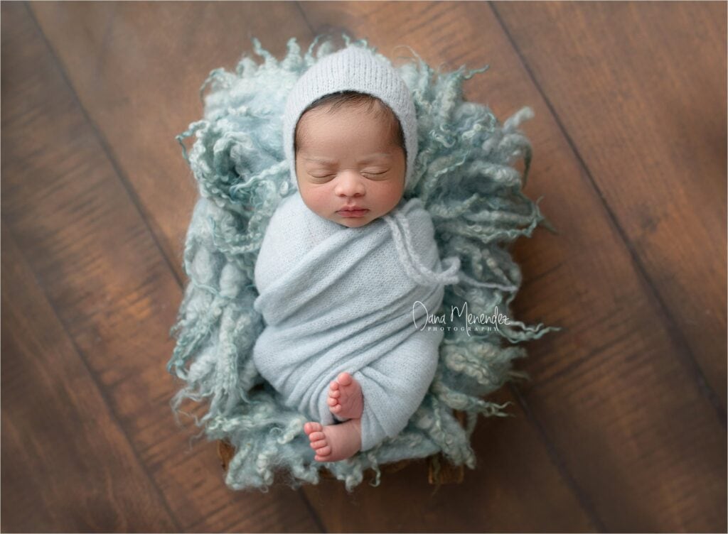 Baby sleeping peacefully wrapped in a soft blanket.