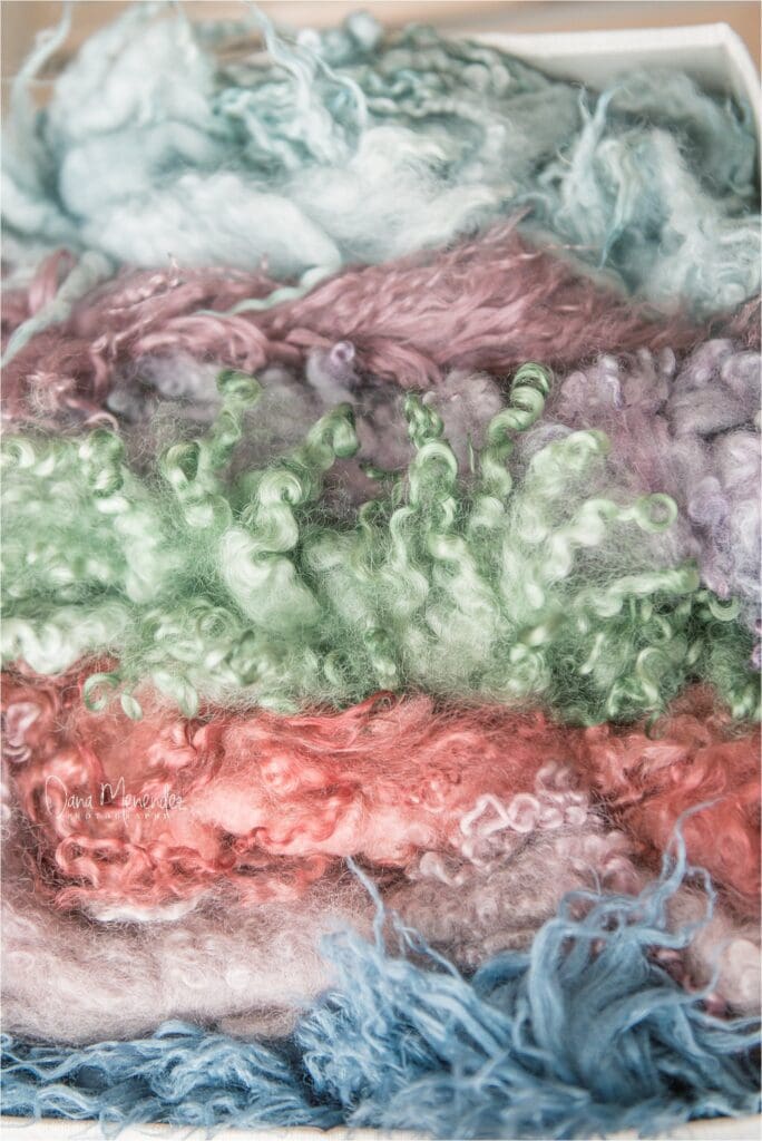Soft pastel-colored wool fibers for newborn photography props.