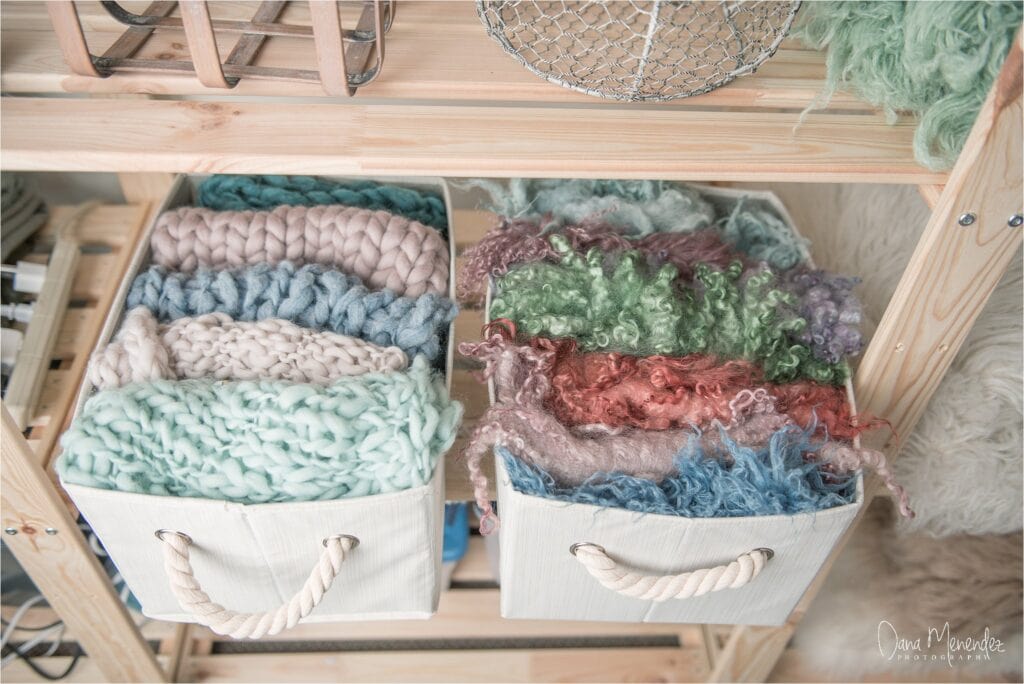 Yarn storage with various textured, colorful yarns in baskets for knitting or crochet.