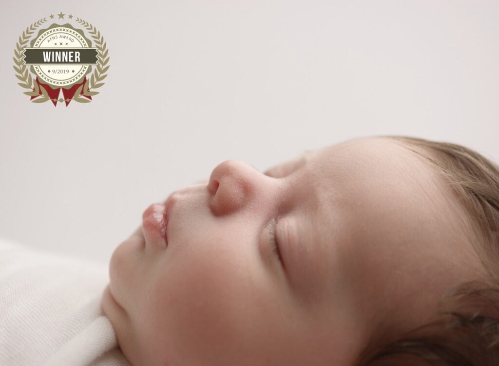 Baby sleeping peacefully during a newborn photoshoot in Okotoks.