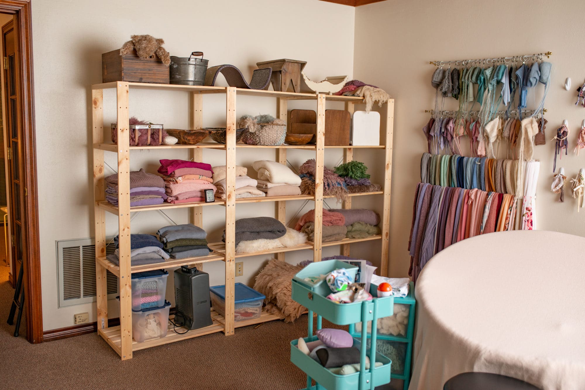 Bright craft room with organized shelves and colorful fabric swatches on the wall calgary ab