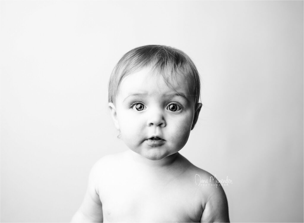 Baby portrait with expressive eyes in black and white.