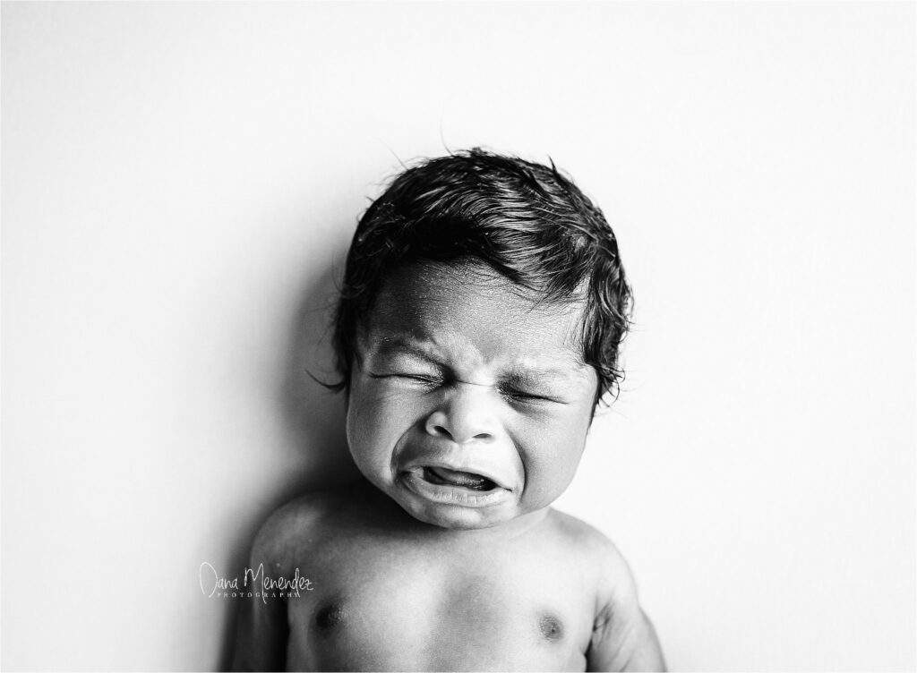 Baby crying portrait in black and white.