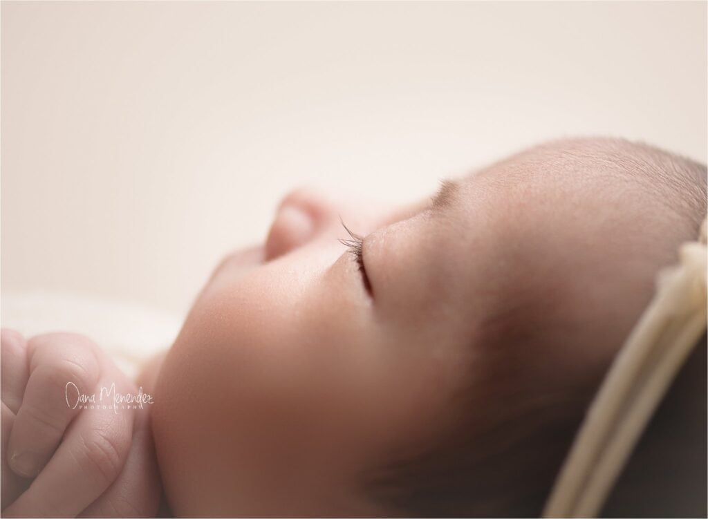 Close-up of sleeping newborn baby Giselle with peaceful expression.