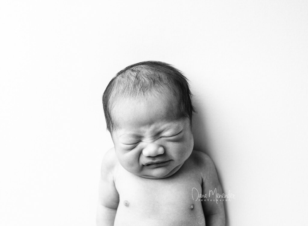 Newborn baby crying, black and white portrait, Dana Menendez.