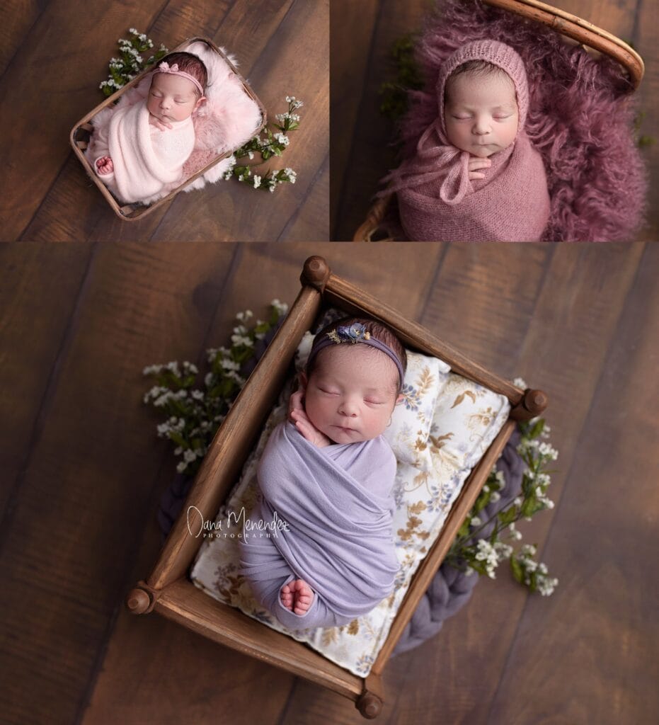 Newborn baby girl peacefully sleeping in a basket with flowers.