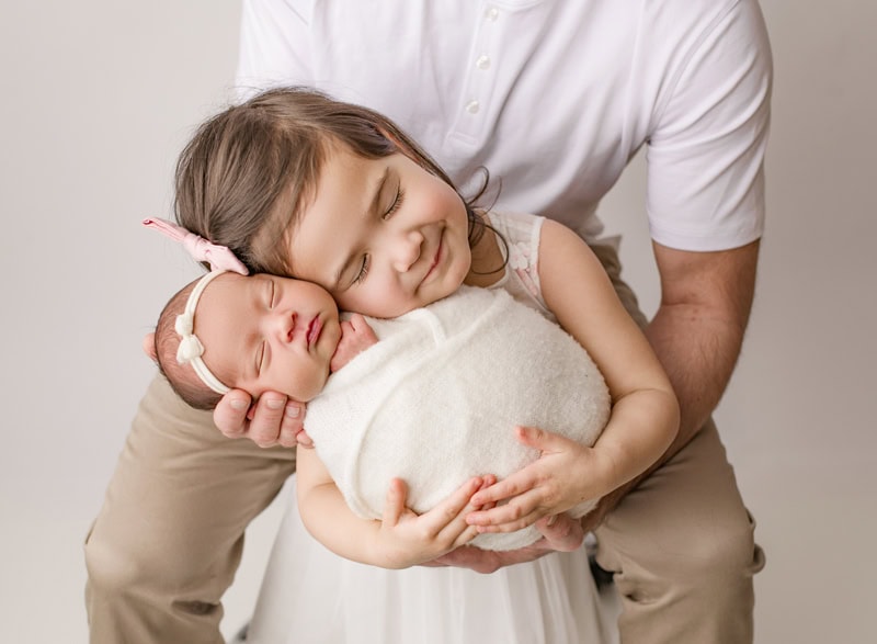 Baby girl peacefully sleeping with her mother’s support in okotoks alberta