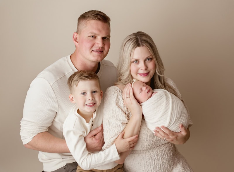 Family newborn portrait in Okotoks with parents and baby.