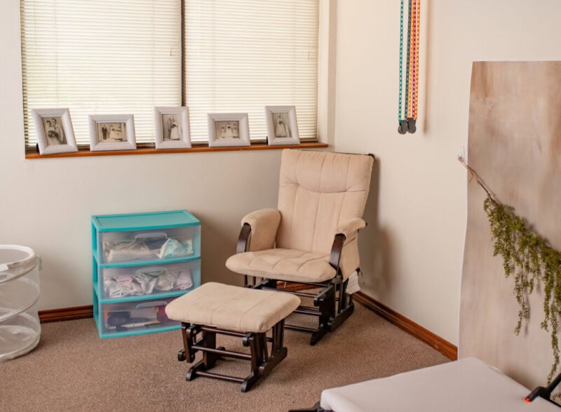 Calgary newborn photography studio with cozy chair and decor.