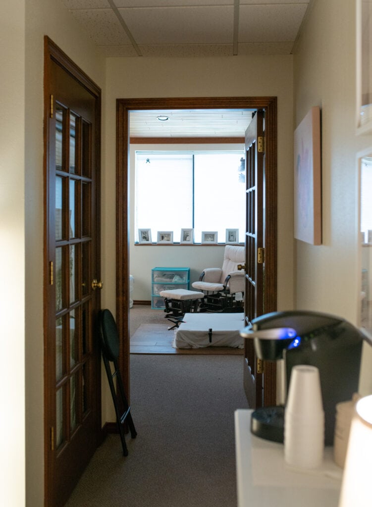 Interior view of a Calgary newborn photography studio with a cozy setup and natural light.